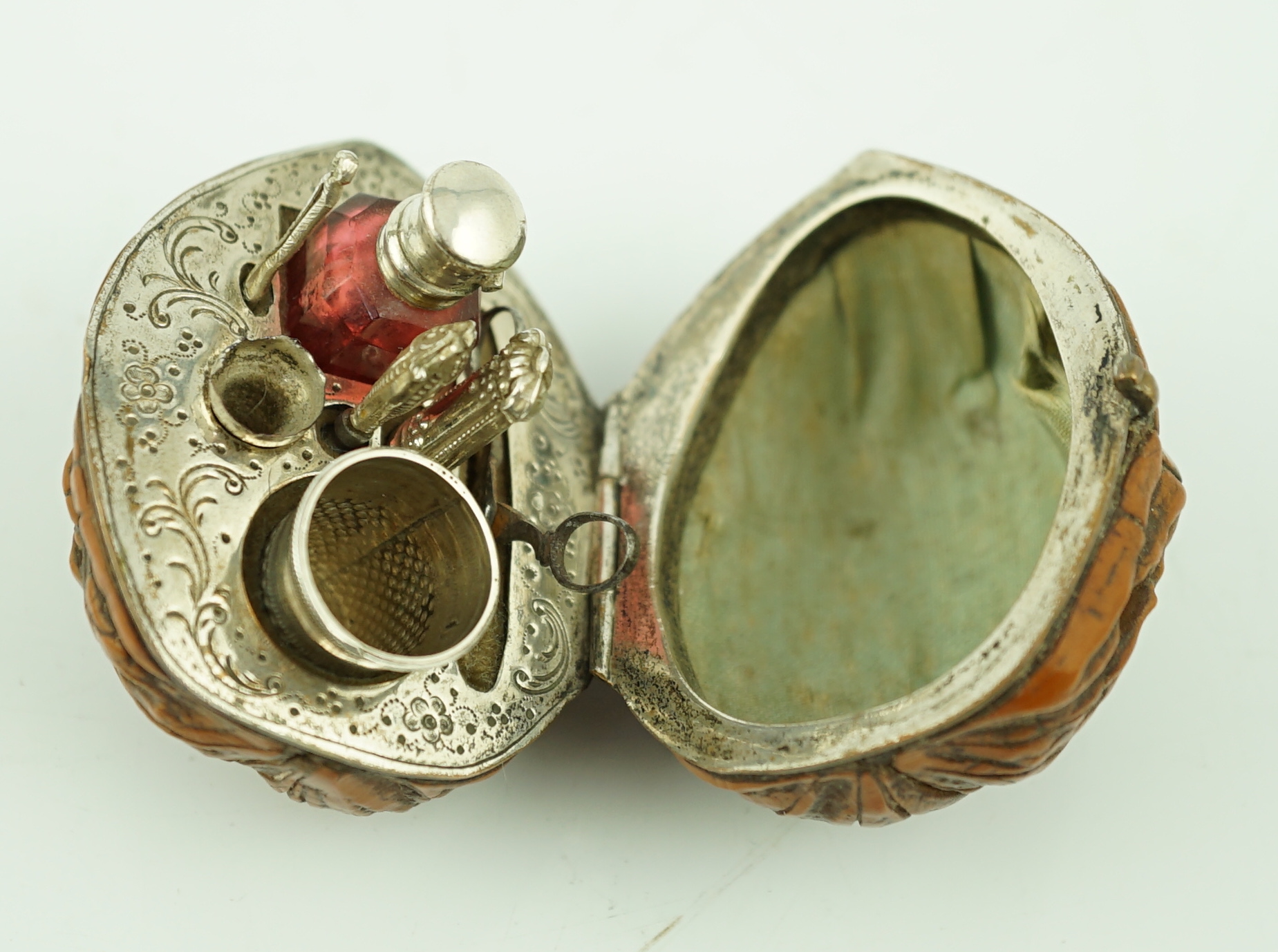 A 19th century French novelty etui case, modelled as a walnut, containing six silver or silver mounted implements